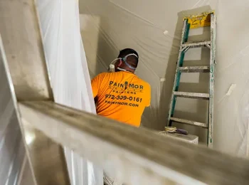 PintMor Painters worker painting the interior of an office space.