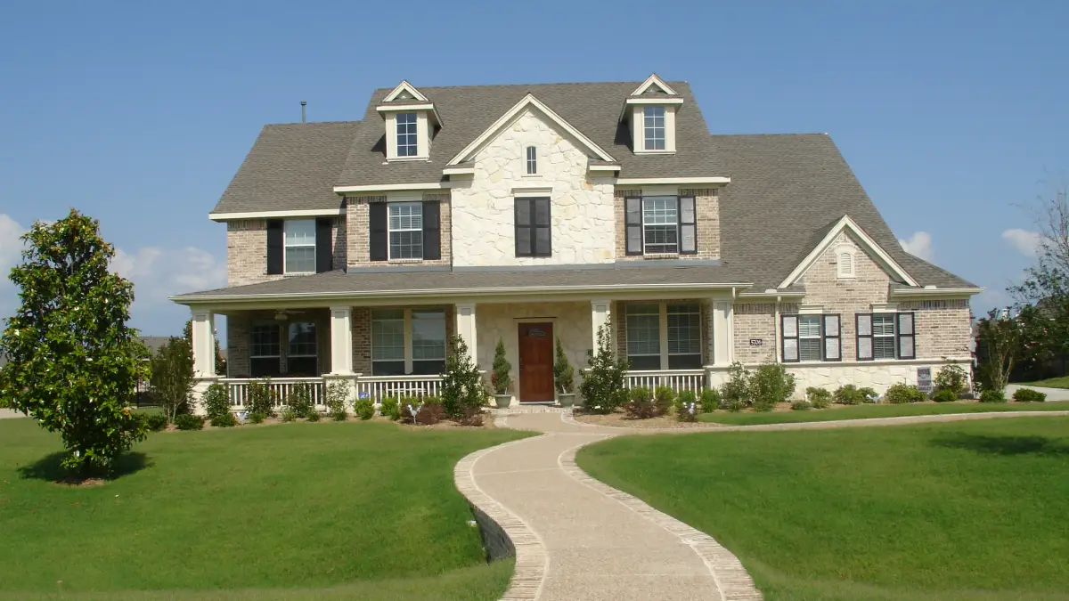 Professional exterior home painting on a North Texas house during favorable summer morning conditions.