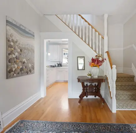 Clean high-traffic entryway in a summer home prep North Texas home refreshed for summer with light walls and organized family spaces
