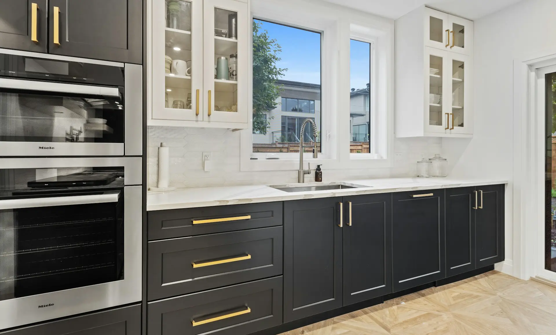 PaintMor Painters kitchen painting cabinet painting. Black bottom cabinets and white upper cabinets in a kitchen
