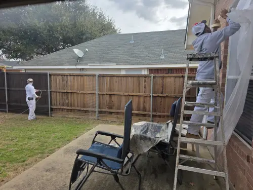 Paintmor workers preping the house to protect it while they do fence staining