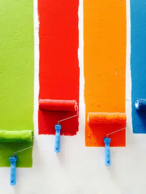 a row of paint rollers on a wall