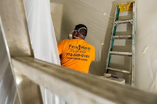 PintMor Painters worker painting the interior of an office space.