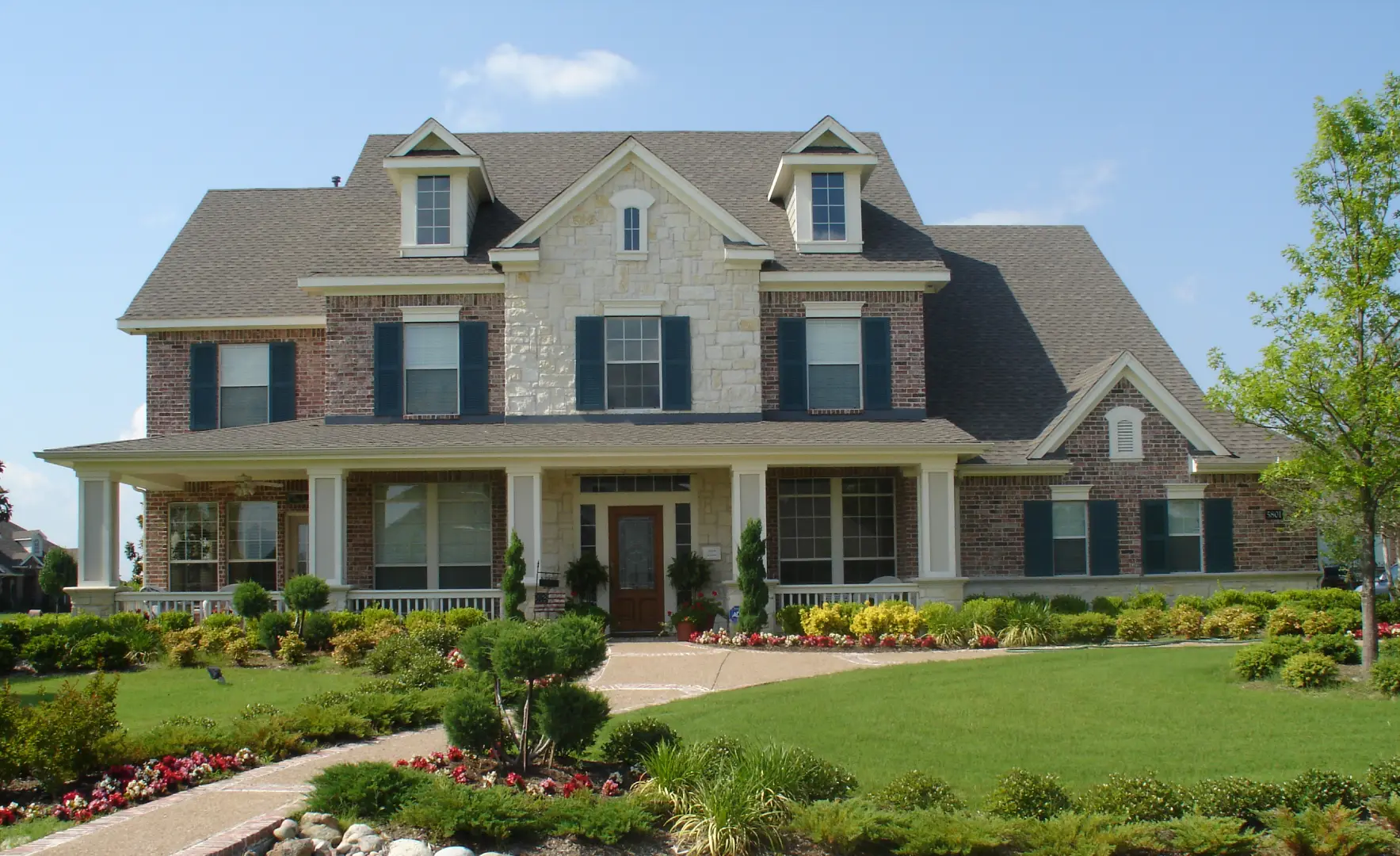 a house with a lawn to showcase when to paint my house exterior with PaintMor Painters