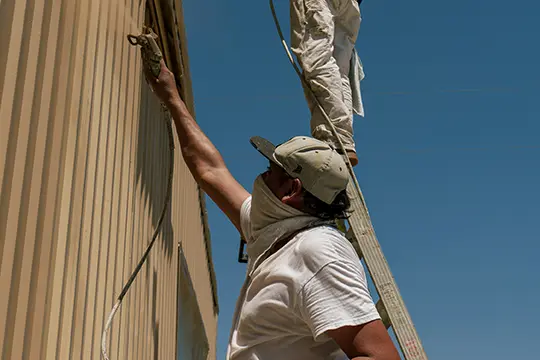 PaintMor Painters professional exterior painters in McKinney showing painters painting an external garage at a house in McKinney.