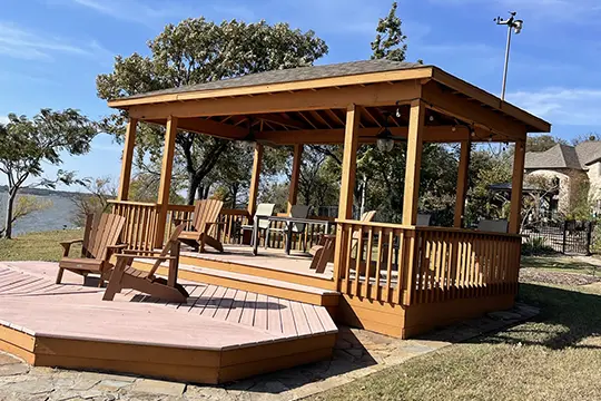 PaintMor Painters professional fence and deck staing and painters in Frisco showing a brown stained gazeebo in Frisco.