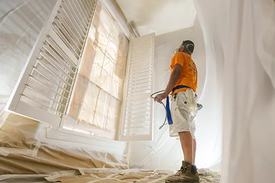 PaintMor Painters professional interior painters in Allen showing our painter prepping an interior room.