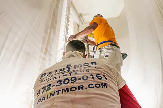 PaintMor Painters professional interior painters in Carrollton showing our painters prepping an interior room for painting.